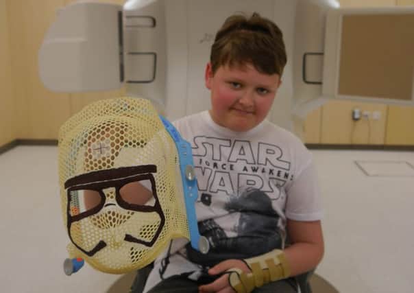 Reece Holt, 10, who is undergoing radiotherapy treatment after being suddenly diagnosed with a brain tumour.
Reece with his specially made Storm Troopers mask for his radiotherapy treatment.