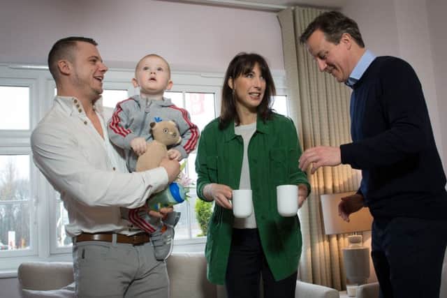 Prime minister David Cameron and his wife Samantha meet first time home buyer Robert Arron (left) and his son Finlay at the Heritage Brook housing development in Chorley, Lancashire, where he has used the government's Help To Buy scheme to purchase their home. PRESS ASSOCIATION Photo. Picture date: Friday April 3, 2015. See PA story ELECTION Cameron. Photo credit should read: Stefan Rousseau/PA Wire