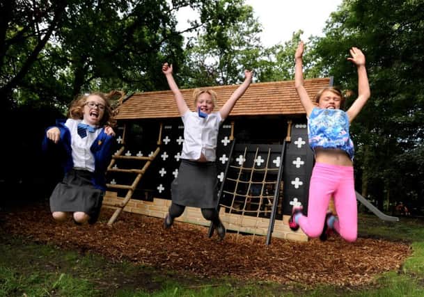 Youngsters from local primary schools plus nearby residents were invited to the opening of Salisbury Hall's latest attractions. The children got the chance to eat at the new Wafflery and then play on a wooden climbing feature based on the Mayflower ship and a mini Salisbury Hall. L-r Esme Booth, Sacha Swarbrick and Madeline Dixon in front of the mini hall. Picture by Paul Heyes, Tuesday July 12, 2016.