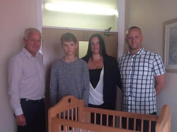 Phil Simpson, of Simpson's of Colne, who made the cuddle cot, with Oliver Parsons, Sarah Bernasconi and Mark Parsons at Derian House