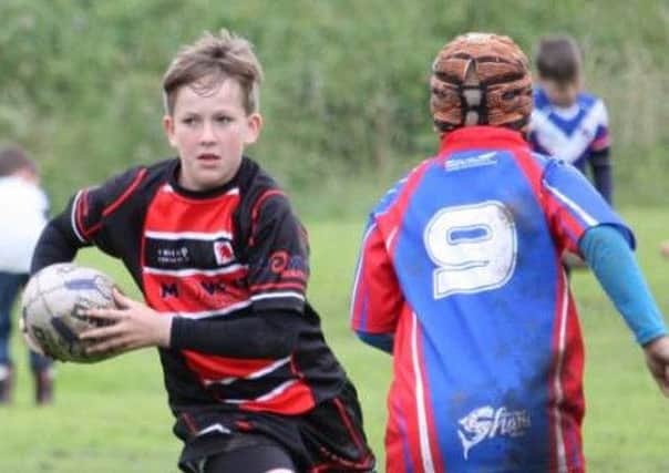 Warriors Under-11s (red and black) on the front foot