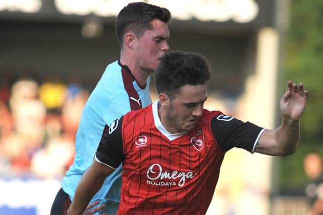 Goal scorer Rhys Turner battles with Michael Keane at the Globe Arena on Tuesday night. Picture: Rob Lock