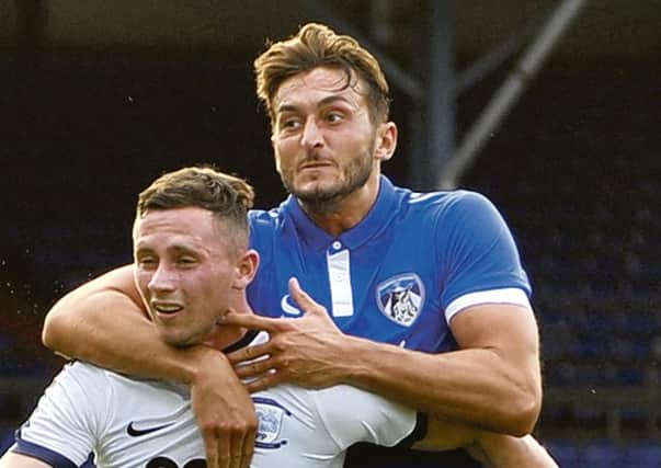 Alan Browne gets some close attention from an Oldham defender