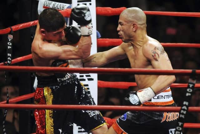 Miguel Cotto, right, of Puerto Rico, lands a punch against Michael Jennings,  in the fifth round of their WBO World Welterweight title fight at Madison Square Garden in New York, in 2009