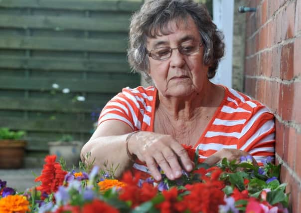 FLORAL: Barbara Proffit in the garden that was her pride and joy before thieves struck