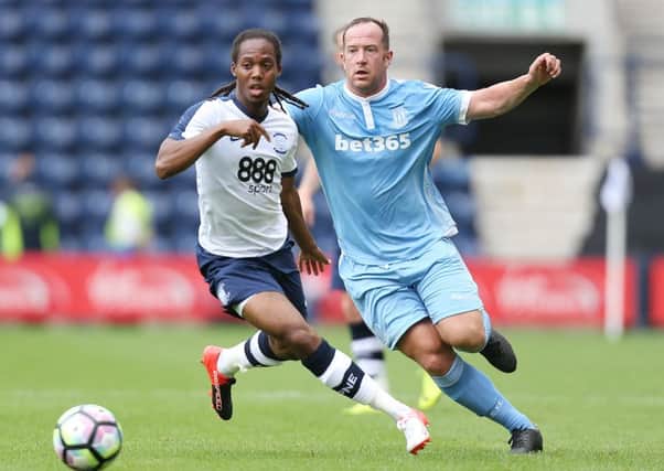 Daniel Johnson challenges Charlie Adam. Photo: Barry Coombs/PA Wire.