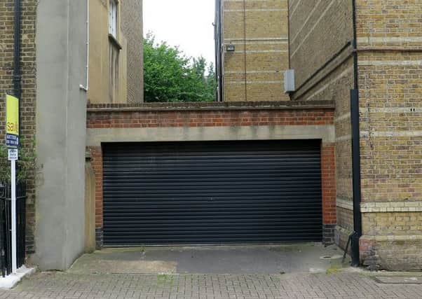 The garage in London which has a guide price of GBP525,000.  An investor who parked his cash in a garage is set to make a fortune next week by selling the lockup for more than Â£500,000.  See SWNS story SWGARAGE.  The double garage is sandwiched between two large homes near the River Thames in Chelsea, south-west London.  It is attracting the bumper price-tag because the owner has managed to get planning permission to convert the garage into a one-bedroom home.  But there is a good chance the 332 sq/ft garage could sell for even more when considering the prices they have been fetching in the area recently.  Savills Auctions, which is selling the garage, have sold two lock-ups in the area this year for almost twice the sale estimate.  Whoever buys the garage can knock it down and replace it with a one-bedroom home spread over two storeys, as well as a basement.  Plans for the work were submitted to the Royal Borough of Kensington and Chelsea in July 2014 and, despite a number of objections from locals, were app