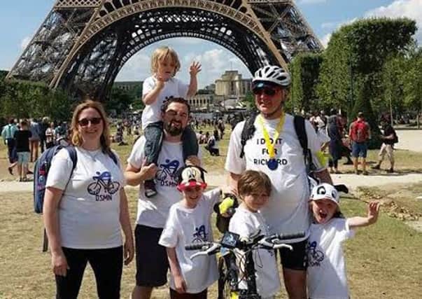 John Farden at the Eiffel Tower in Paris having cycled 300 miles in memory of his son in law Ric Clarke