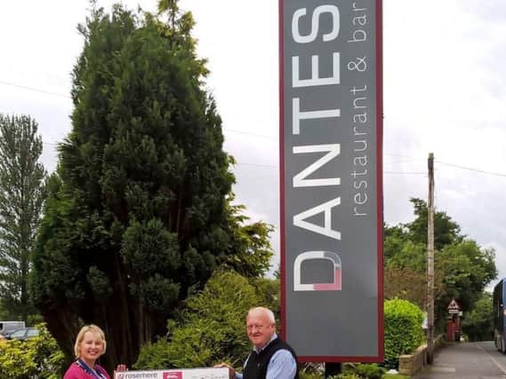 Dantes proprietor Nick White presents Rosemeres corporate fund-raising manager Cathy Skidmore with the proceeds of his novel water aid scheme