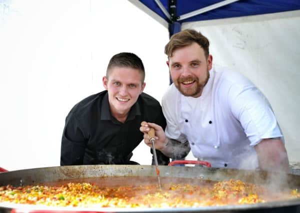 Drew Gough and Paul Carlton prepare a seafood paella at the Lancashire Market at Friargate Brow, Preston