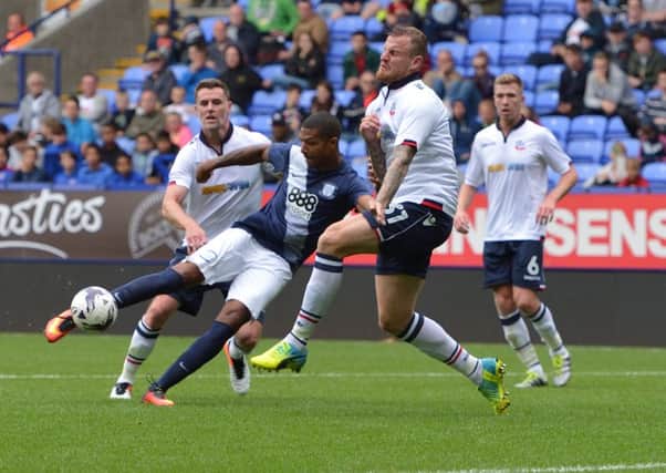 Jermaine Beckford tries his luck with a shot at the Macron Stadium