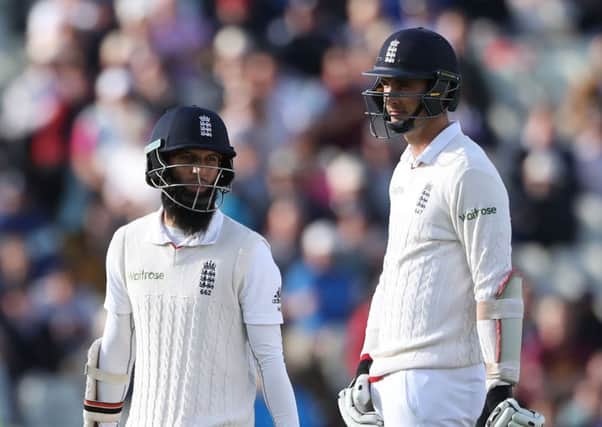 England batsman Moeen Ali walks past Steven Finn (right) after he was out for 63 to Pakistan bowler Mohammad Amir