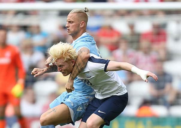 Tussling with Stoke City's Marko Arnautovic during the pre-season friendly match at Deepdale