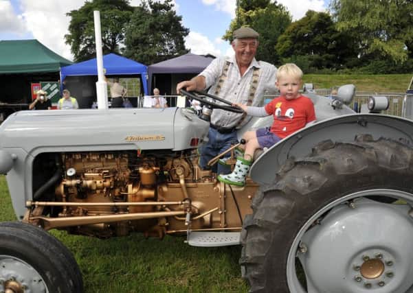 Richard Lawrenson from Pilling with Grandson Tom Lawrenson who sits in one of the many tractors on display at Garstang Show