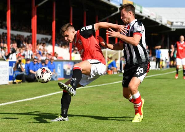 Aaron McGowan under pressure at Grimsby on Saturday. Picture: Duncan Young
