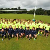 Rugby youngsters line up for a team photo with their Sale Sharks heroes