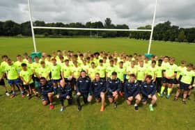 Rugby youngsters line up for a team photo with their Sale Sharks heroes