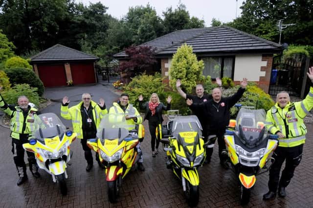 TV presenter Rav Wilding with members of North West Blood Bikes who have been given a National Lottery award