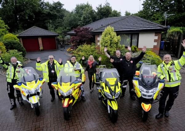 TV presenter Rav Wilding with members of North West Blood Bikes who have been given a National Lottery award