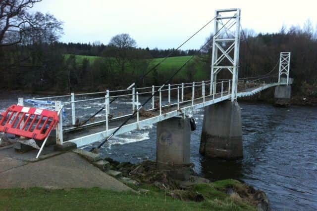 The damaged Dinckley Suspension Bridge near Hurst Green - closed after the Ribble  burst its banks on December 26