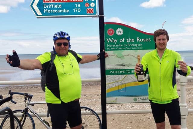 Paul and James Housden in Bridlington at the end of their Coast to Coast cycling challenge on behalf of Children of the Far East Prisoners of War charity