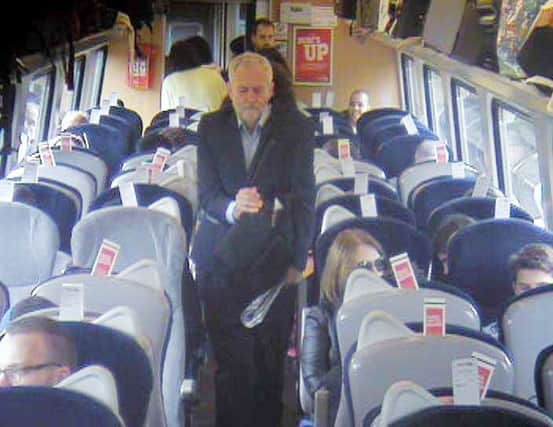 Jeremy Corbyn captured  on CCTV walking past empty seats on a Virgin train.