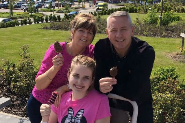 Hannah Lyson, 19, with her parents Beth and Mark enjoying an ice cream after her bowel cancer surgery