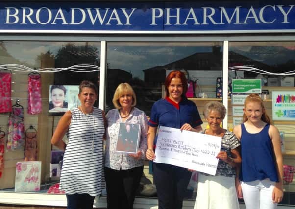 The team at Broadway Pharmacy, Garstang Road, Preston raise more than Â£600 for Heartbeat in memory of former colleague and PNE player George Ross. From left to right, Sharon Ross daughter In Law , pharmacy manager Vivienne, Lucy Health Care Assistant and Pat Ross (George's wife with granddaughter Erin