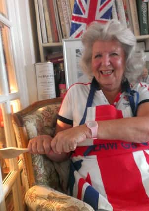 Babs demonstrates how she used her 'lucky oar' to row along with Polly while watching her on TV during the Games.