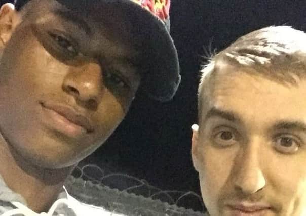 England and Manchester United footballer Marcus Rashford with fan Darryl Lloyd as the star watched Charnock Richard away at Bacup Borough.