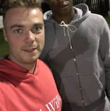 England and Manchester United footballer Marcus Rashford with fan Matt Tighe as the star watched Charnock Richard away at Bacup Borough.