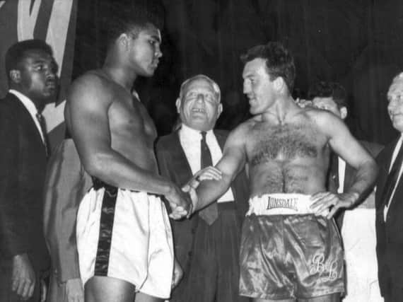 Brian London face to face with Muhammad Ali at the big fight weigh-in. See letter