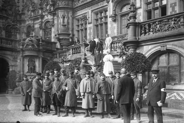 French soldiers on the steps of Le Palais Benedictine .