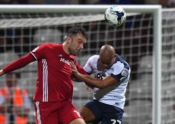 Challenging in the air with Cardiff striker Rickie Lambert