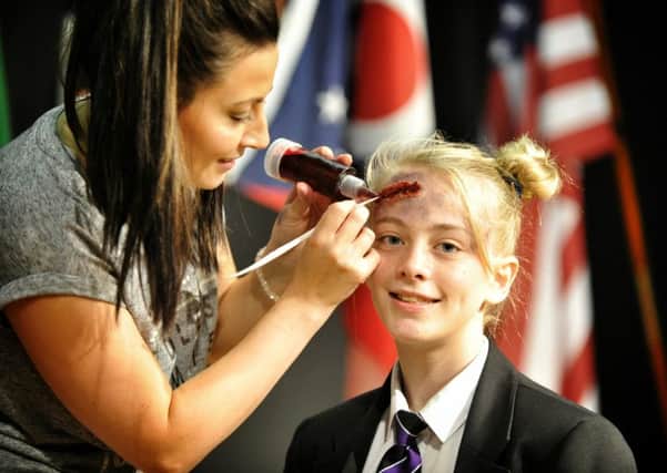 Picture by Julian Brown 17/09/16

Drama teacher Samantha MacPherson puts the finishing touches to a realistic head wound on Rebecca Kay (13)

Worden Academy, Leyland, Health Mela