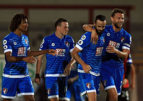 Bournemouth's Marc Wilson (second right) celebrates with team-mate Simon Francis (right) after he scored their second goal during the League Cup second-round win at Morecambe