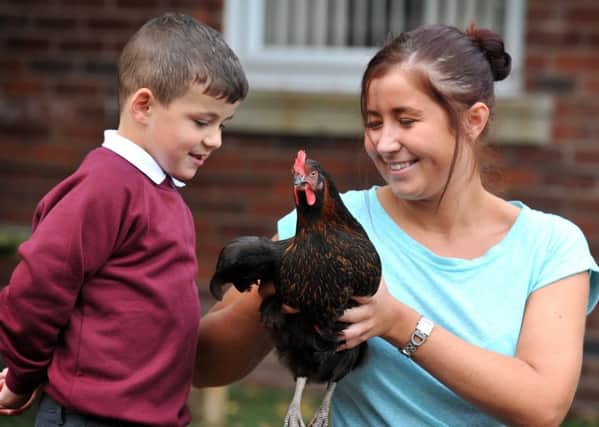 Laura Heap and Kyle with one of the school's chickens last summer