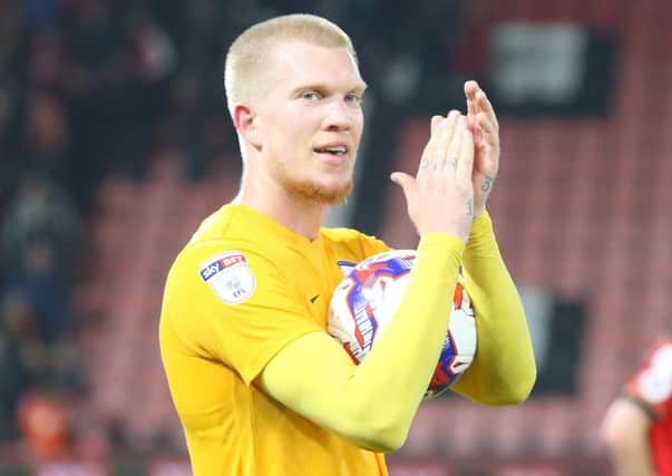 Simon Makienok applauds the fans at the final whistle holding the match ball after scoring a hat-trick

against Bournemouth