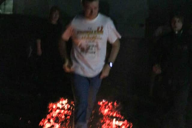 Chris Smith doing the fire walk challenge