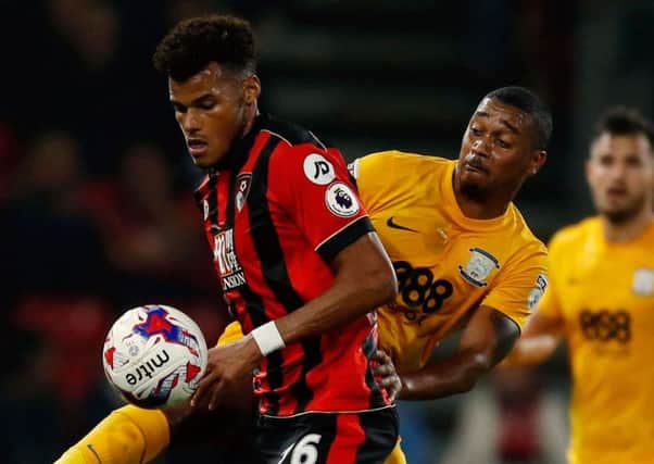 Battling with Bournemouth's Tyrone Mings (left) in Tuesday's League Cup win