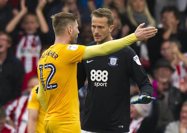 Paul Gallagher and Anders Lindegaard share a word at Brentford