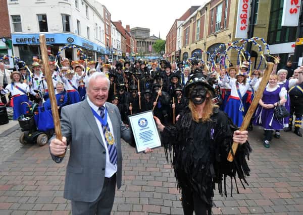 Photo Neil CrossStone the Crows Morris dancers celebrate their Guinness world record for biggest dance with other dancers from the area, in Friargate, PrestonDeputy Mayor Coun Brian Rollo presents the certificate to Cat Holden, the squire of Stone the Crows