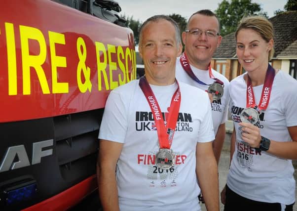 Three retained firefighters from Garstang have successfully completed an Iron Man challenge, and have the tattoos to prove it!
Pic L-R: Chris and Kevin Horner, and Sammie Stuart.  PIC BY ROB LOCK
23-9-2016