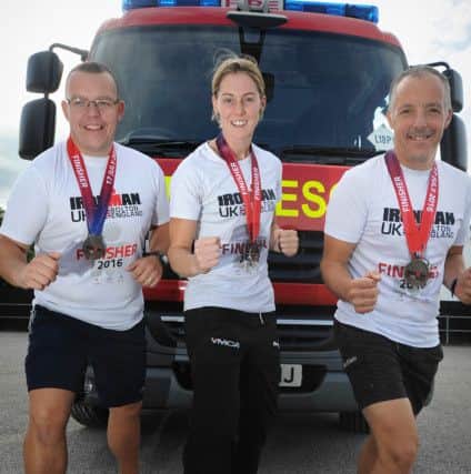Three retained firefighters from Garstang have successfully completed an Iron Man challenge, and have the tattoos to prove it!
Pic L-R: Kevin Horner, Sammie Stuart and Chris Horner.  PIC BY ROB LOCK
23-9-2016