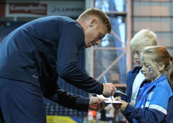 Eoin Doyle signs autographs before the match