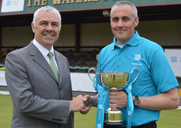 Tim Houghton is presented with his trophy by Steve Jelly, the regional manager for Co-op Funeralcare