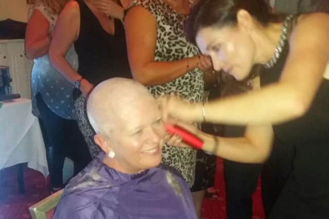 Trish Gainer during her head shave for Cancer Research UK