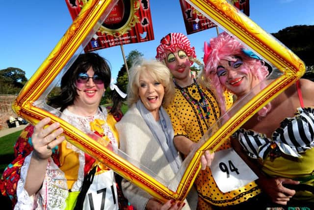 Dames on the Run 5k race for men dressed as women and pantomime dames in aid of Derian House Children's Hospice. The race around Astley Park in Chorley was officially started by actress Sherrie Hewson. Sherrie Hewson with cast members from Snow White at Christ Church, Charnock Richard.