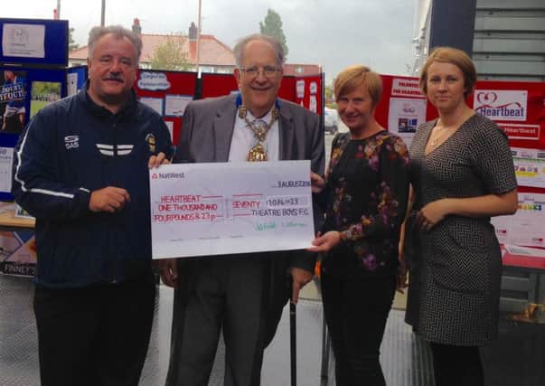 Preston Mayor Coun John Collinson, representatives from the Theatre Boys Football Club present a charity cheque to Heartbeat, Preston