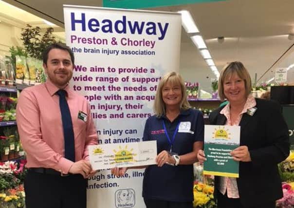 Morrisons Manager Scott Lowe, Headway Manager Liz Bamber and Morrisons Manager Debbie Greenhalgh presenting grant for the new Headway cooking project
